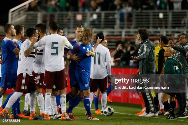 Players from Mexico and Iceland react after an altercation between Birkir Bjarnason of Iceland and Miguel Layun of Mexico during their match at...