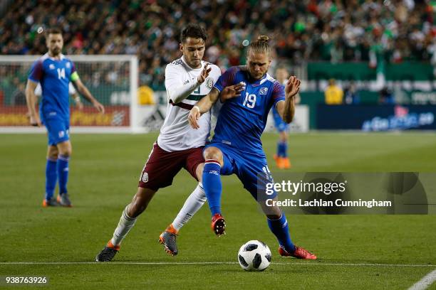 Rurik Gislason of Iceland competes for the ball against Diego Reyes of Mexico during their match at Levi's Stadium on March 23, 2018 in Santa Clara,...