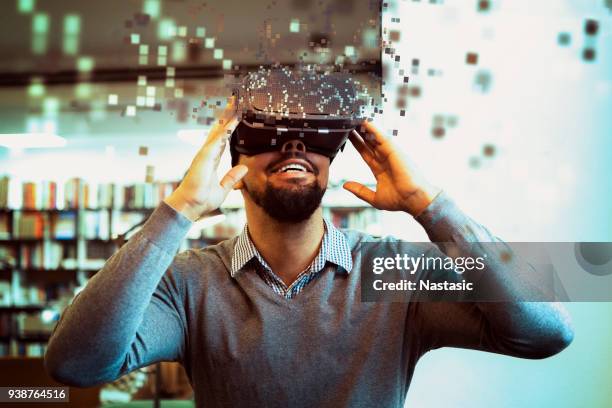 young male student using vr headset - vr stock pictures, royalty-free photos & images