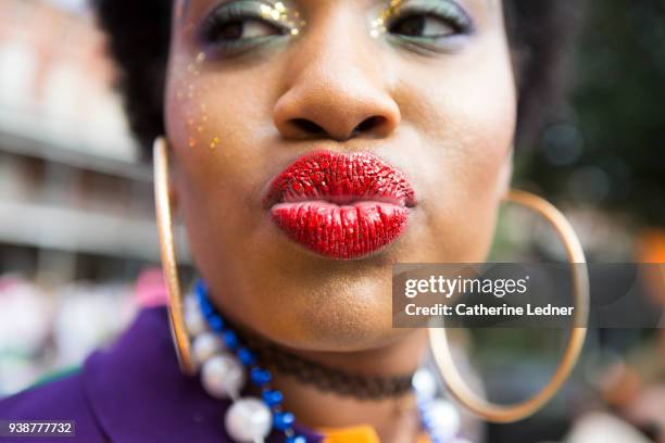 woman with red glitter lipstick on large lips making kissy face - catherine ledner foto e immagini stock