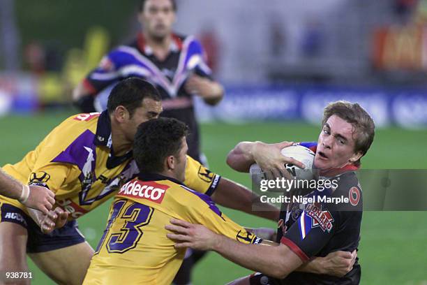 John Carlaw of the Warriors is tackled by Henry Perenara during the National Rugby League Match between the New Zealand Warriors and the Melbourne...