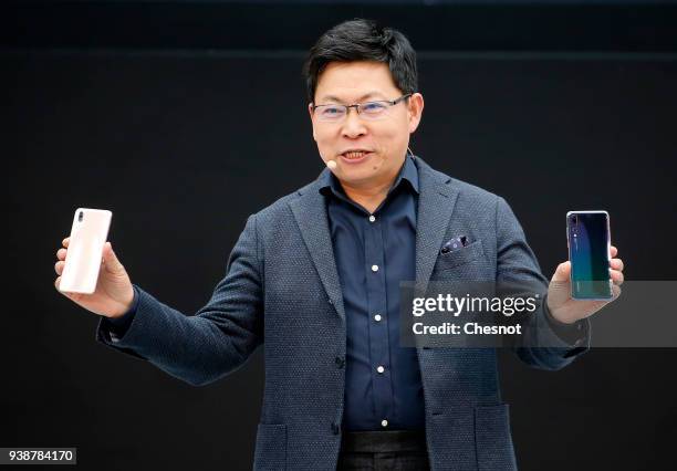 Huawei Consumer Business Group's CEO, Richard Yu holds the new Huawei P20 smartphone during the launching of the new generation smartphones of the...