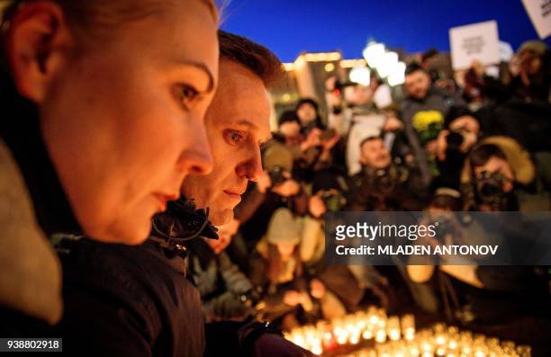 Russian opposition leader Alexei Navalny and his wife Yulia pay tribute with several thousand opposition supporters to the victims of a Siberian...