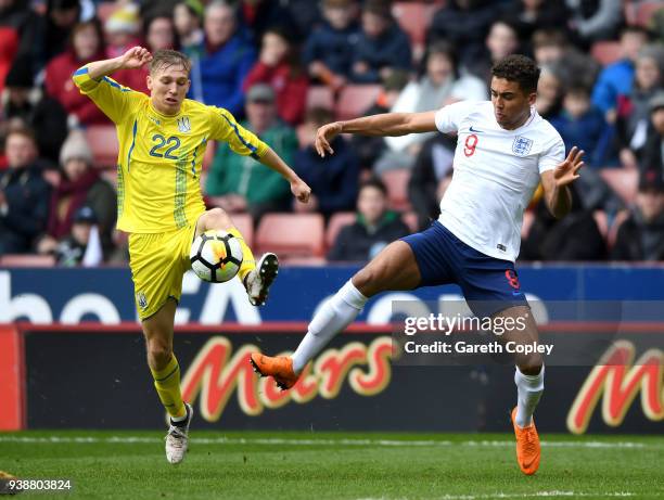 Dominic Calvert-Lewin of England is tackled by Valeriy Luchkevych of Ukraine during the U21 European Championship Qualifier between England U21 and...