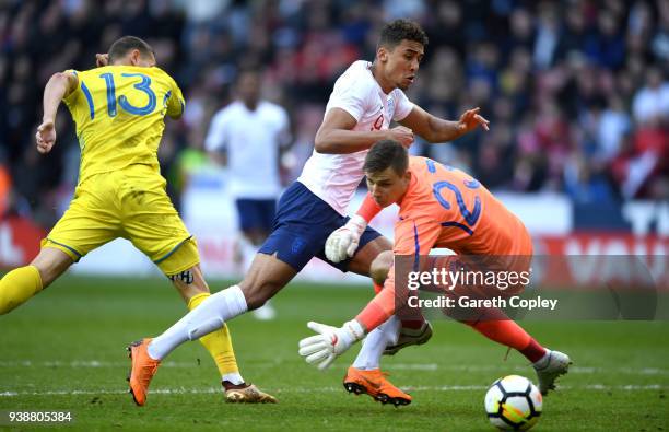 Dominic Calvert-Lewin of England scores the opening goal past Andriy Lunin of Ukraine during the U21 European Championship Qualifier between England...