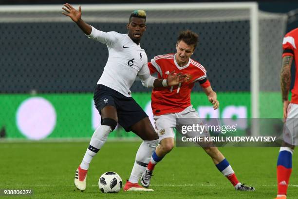 France's midfielder Paul Pogba and Russia's midfielder Alexander Golovin vie for the ball during an international friendly football match between...