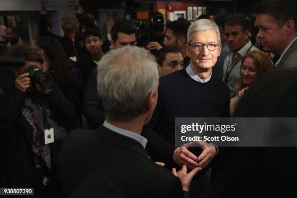 Apple CEO Tim Cook chats with Chicago Mayor Rahm Emanuel during an event held to introduce the new 9.7-inch Apple iPad at Lane Tech College Prep High...