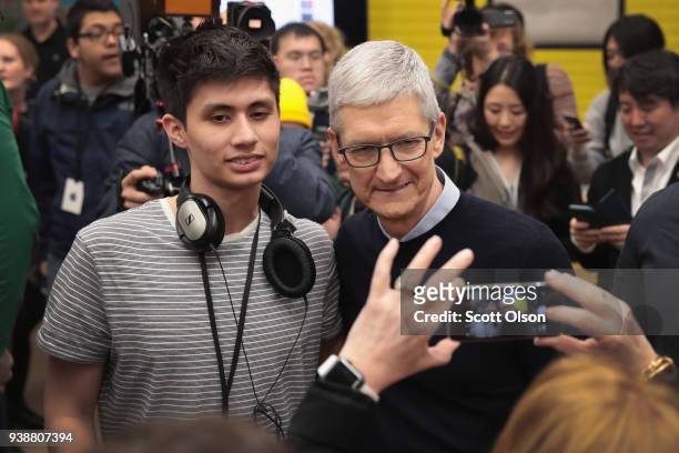 Apple CEO Tim Cook greets guests during an event held to introduce the new 9.7-inch Apple iPad at Lane Tech College Prep High School on March 27,...