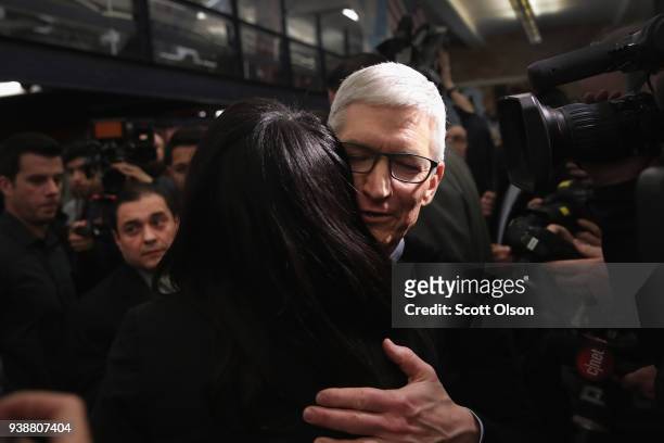 Apple CEO Tim Cook greets guests during an event held to introduce the new 9.7-inch Apple iPad at Lane Tech College Prep High School on March 27,...