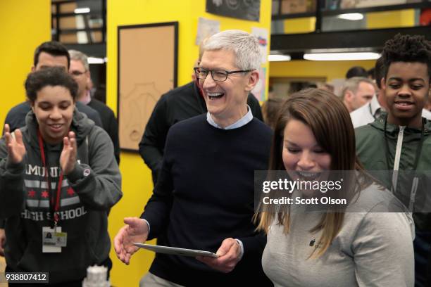 Apple CEO Tim Cook gets a demonstration of an app during an event held to introduce the new 9.7-inch Apple iPad at Lane Tech College Prep High School...