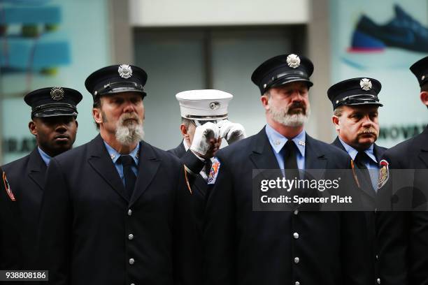 Members of the fire department watch the funeral procession for New York City firefighter Lt. Michael Davidson at St. Patrick's Cathedral on March...