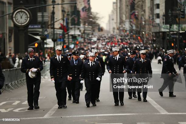 Firefighters walk down 5th Ave. After the funeral for New York City firefighter Lt. Michael Davidson at St. Patrick's Cathedral on March 27, 2018 in...