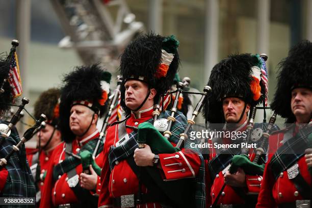 Members of the FDNY Emerald Society Pipes snd Drums watch the funeral procession for New York City firefighter Lt. Michael Davidson at St. Patrick's...