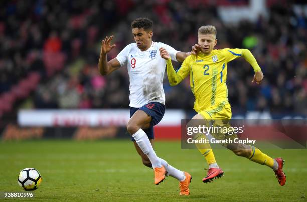 Dominic Calvert-Lewin of England is tackled by Pavlo Lukyanchuk of Ukraine during the U21 European Championship Qualifier between England U21 and...