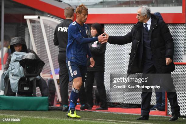 Vahid Halilhodzic, manager of Japan, shakes the hands with Keisuke Honda of Japan after subsititution at Stade Maurice Dufrasne on March 27, 2018 in...