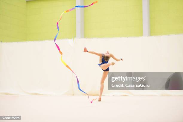 young rhythmic gymnastics athlete dancing with ribbon - ribbon-routine-rhythmic-gymnastics stock pictures, royalty-free photos & images