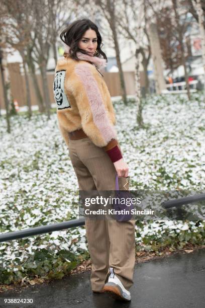 Fashion blogger Deborah Reyner Sebag wears a Coach fur coat, Tara Zadeh bag, Max Mara trousers and Stelle McCartney trainers day 4 of Paris Womens...