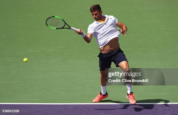 Filip Krajinovic of Serbia plays a forehand against Juan Martin Del Potro of Argentina in their fourth round match during the Miami Open Presented by...