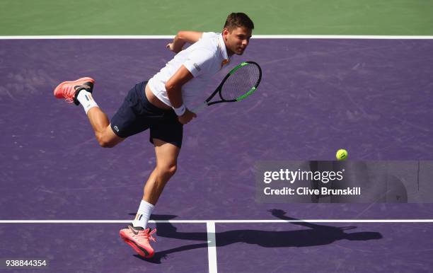 Filip Krajinovic of Serbia plays a backhand volley against Juan Martin Del Potro of Argentina in their fourth round match during the Miami Open...