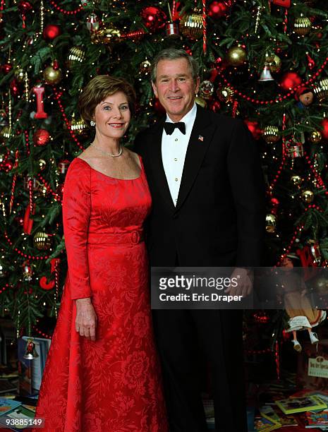 President George W. Bush and Laura Bush pose for their official Christmas portrait in front of the White House Christmas Tree in the Blue Room, Dec....