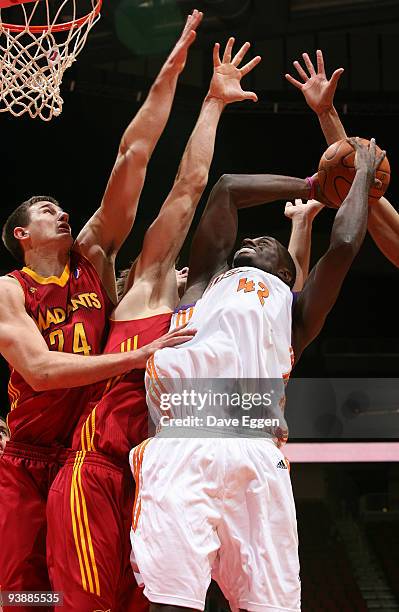 Earl Barron of Iowa tries to get a shot off past the defense of Rob Kurtz and Sean Sonderleiter of Fort Wayne in the second half of their NBA...