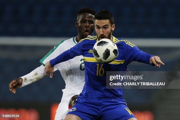 Senegal's Papy Djilobodji vies with Bosnia's Riad Bajic during the international friendly football match between Senegal and Bosnia at the Stadium...