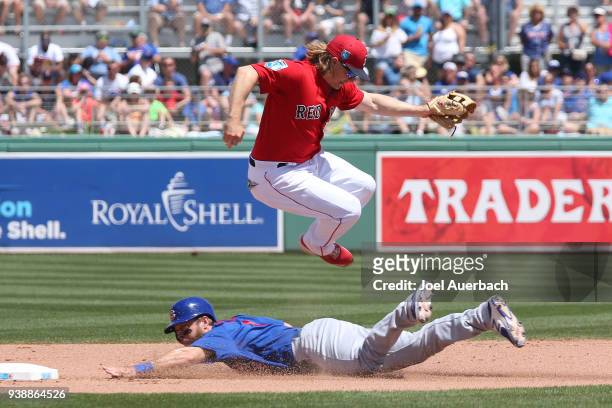 Mike Freeman of the Chicago Cubs steals second base before Brock Holt of the Boston Red Sox can tag him during the fourth inning of a spring training...