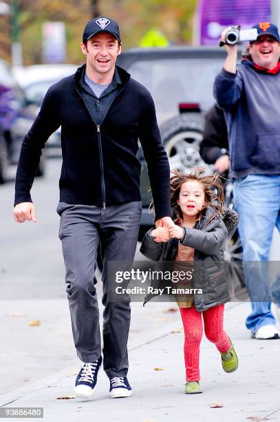 Actor Hugh Jackman and his daughter Ava Jackman walk in Greenwich Village on December 03, 2009 in New York City.