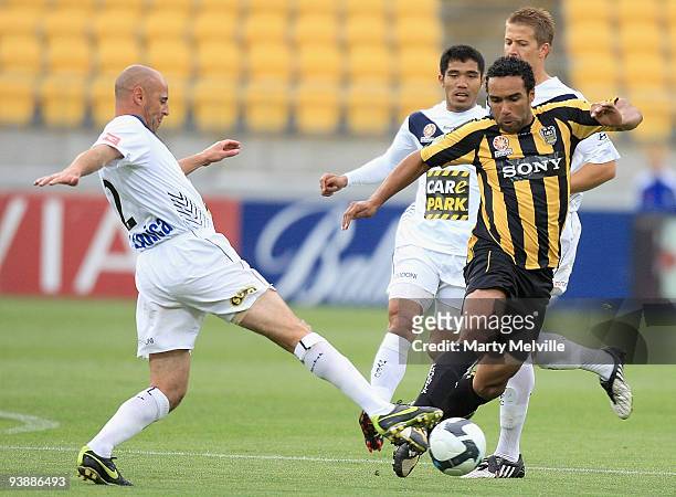 Paul Ifill of the Phoenix is tackled by Kevin Muscat of the Victory during the round 17 A-League match between the Wellington Phoenix and the...