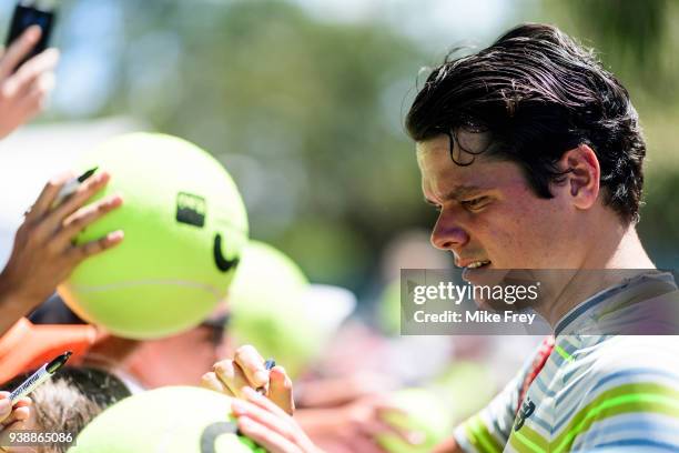 Milos Raonic of Canada signs autographs and takes selfies after beating Jeremy Chardy of France 6-3 6-4 during Day 9 of the Miami Open Presented by...