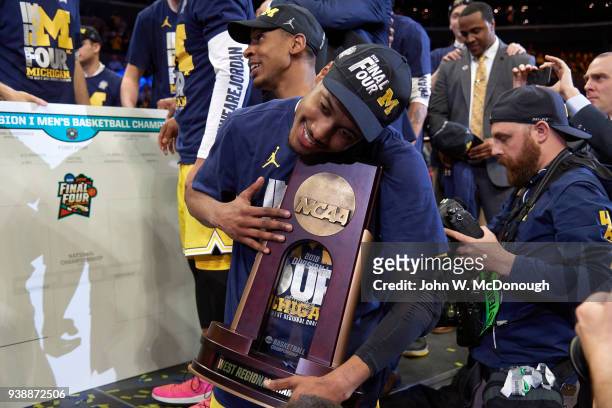 Playoffs: Michigan Muhammad-Ali Abdur-Rahkman victorious holding West Regional Championship trophy after winning game vs Florida State at Staples...