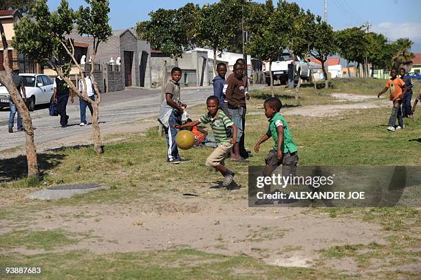 Boys play football in the Gugulethu township outside of Cape Town on December 2, 2009. With the draw for the World Cup 2010 turning Cape Town into a...