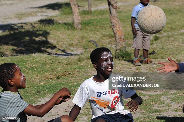 Boys play football in the Gugulethu township outside of Cape Town on December 2, 2009. With the draw for the World Cup 2010 turning Cape Town into a...