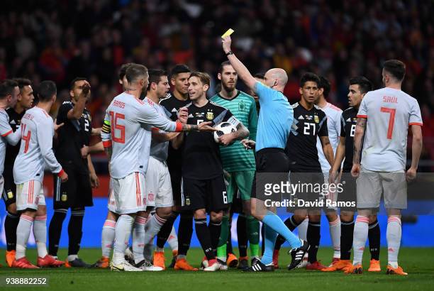 Sergio Ramos of Spain is shown a yellow card by referee Anthony Taylor during the International Friendly between Spain and Argentina on March 27,...