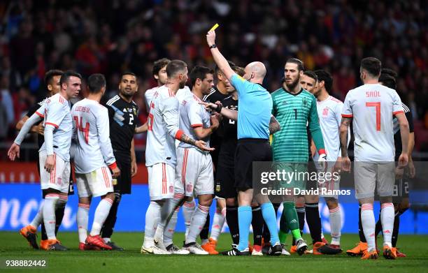 Sergio Ramos of Spain is shown a yellow card by referee Anthony Taylor during the International Friendly between Spain and Argentina on March 27,...