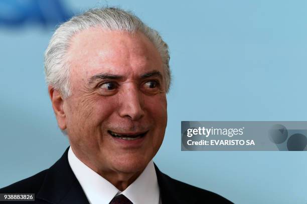 Brazilian President Michel Temer gestures during the ceremony to grant the Order of Medical Merit at the Planalto Palace in Brasilia on March 27,...