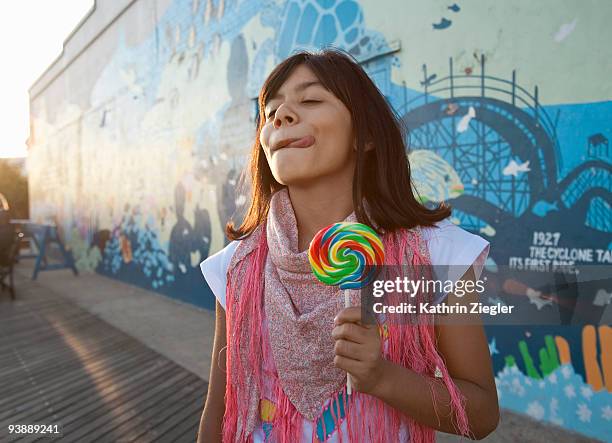 young girl with lollipop on the boardwalk - graffiti hintergrund stock pictures, royalty-free photos & images