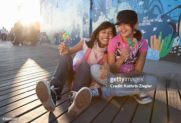 two young girls with lollipops - coney island photos et images de collection