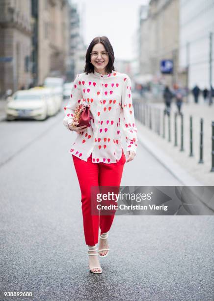Maria Barteczko wearing white heart printed blouse Alexander McQueen, red cropped pants Alexander McQueen, white high heel sandals Giuseppe Zanotti,...