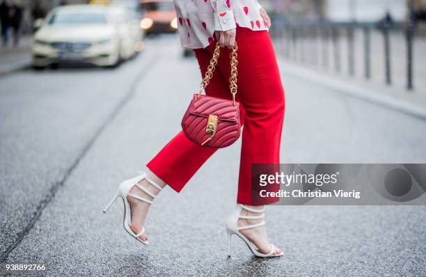Maria Barteczko wearing white heart printed blouse Alexander McQueen, red cropped pants Alexander McQueen, white high heel sandals Giuseppe Zanotti,...