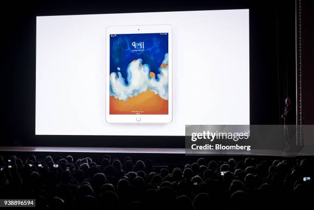 Attendees view an image of the new Apple Inc. IPad displayed on a screen during an event at Lane Technical College Prep High School in Chicago,...