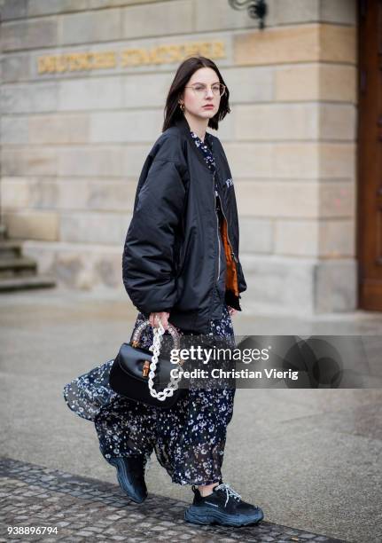 Maria Barteczko wearing long floral maxi dress Isabel Marant, black oversized bomber jacket MUF10, triple S sneaker Balenciaga, black bamboo bag...