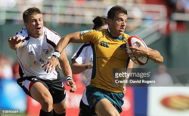 Clinton Sills of Australia races away to score a try against the Arabian Gulf during the IRB Sevens tournament at the Dubai Sevens Stadium on...