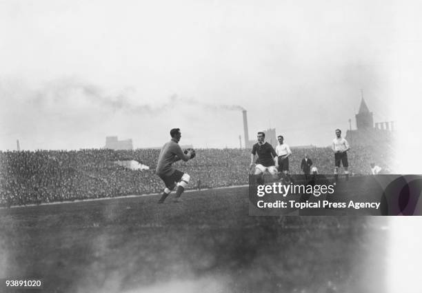 The Tottenham Hotspur goalkeeper about to make a clearance during a league match against Manchester United at Old Trafford, 4th October 1913....