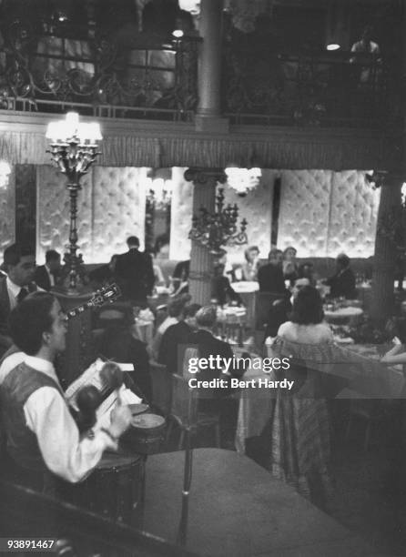 John Kerrison's rhumba-style band plays on a busy evening at the Cafe de Paris nightclub in London, February 1951. Original publication: Picture Post...