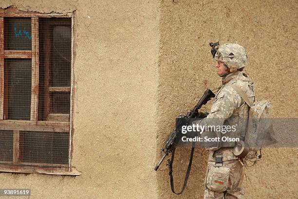 Jeremy Gleason of Beeville, TX from the Army's Blackfoot Company 1st Battalion 501st Parachute Infantry Regiment keeps watch while on a joint patrol...