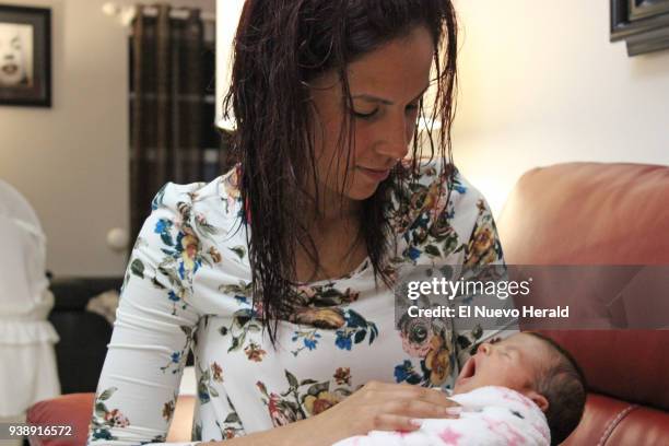 Nairobis Pacheco with newborn Valeria, daughter of her cousin Yarisleidy Cuba Rodriguez, who died of complications during childbirth in Miami.