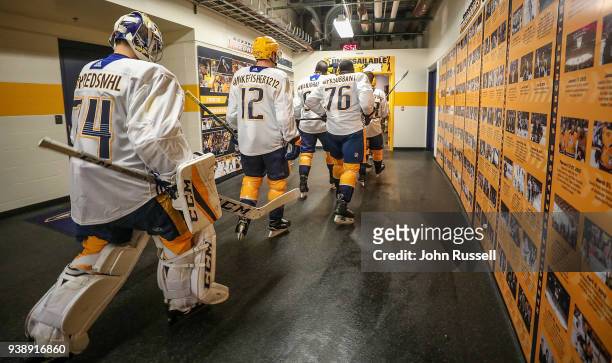 Subban, Mike Fisher and Juuse Saros of the Nashville Predators walk to the ice for warmups wearing their social media tags prior to an NHL game...