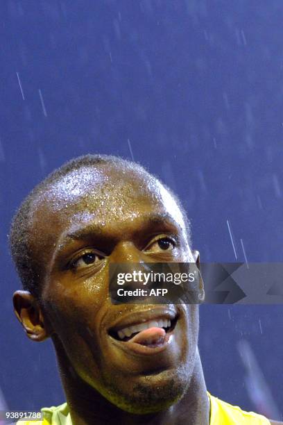 Jamaican Usain Bolt celebrates after he won under pouring rain the men's 200 meters races during the IAAF Super Grand Prix meeting Athletissima, on...