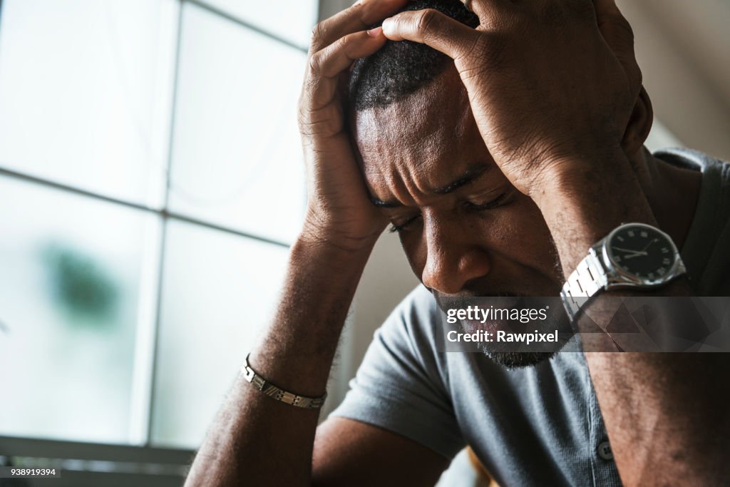 Black guy stressing and headache